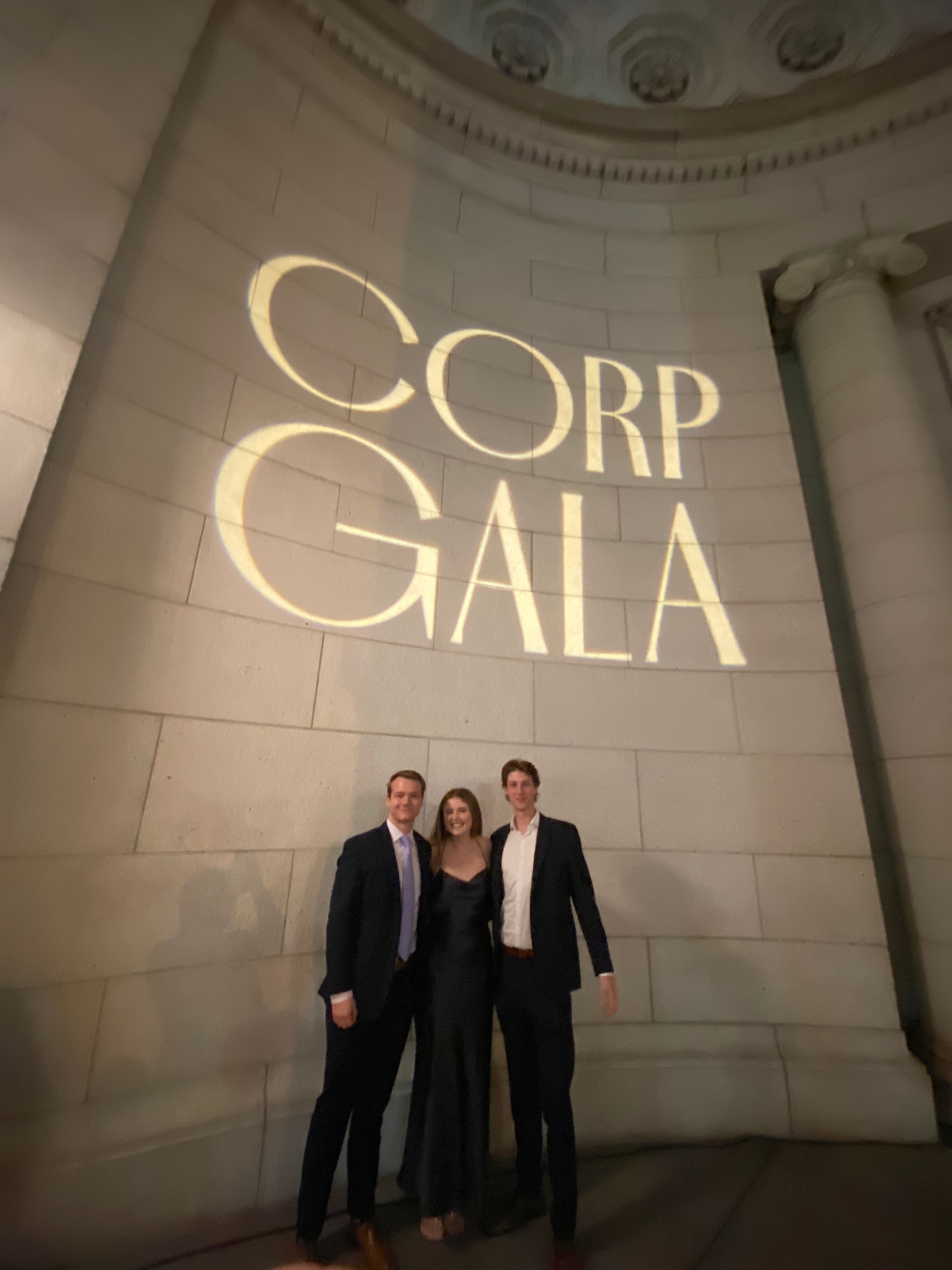 Georgie Wilson stands outside Union Station with two male friends in suits.