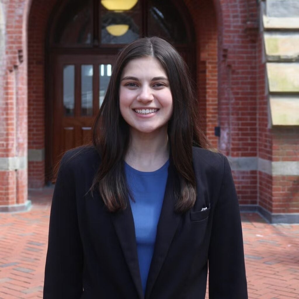 Grace Parcover wearing a black blazer and a blue blouse.
