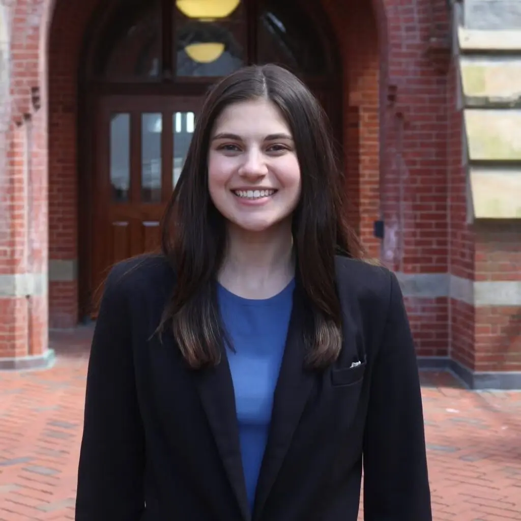 Grace Parcover wearing a black blazer and a blue blouse.