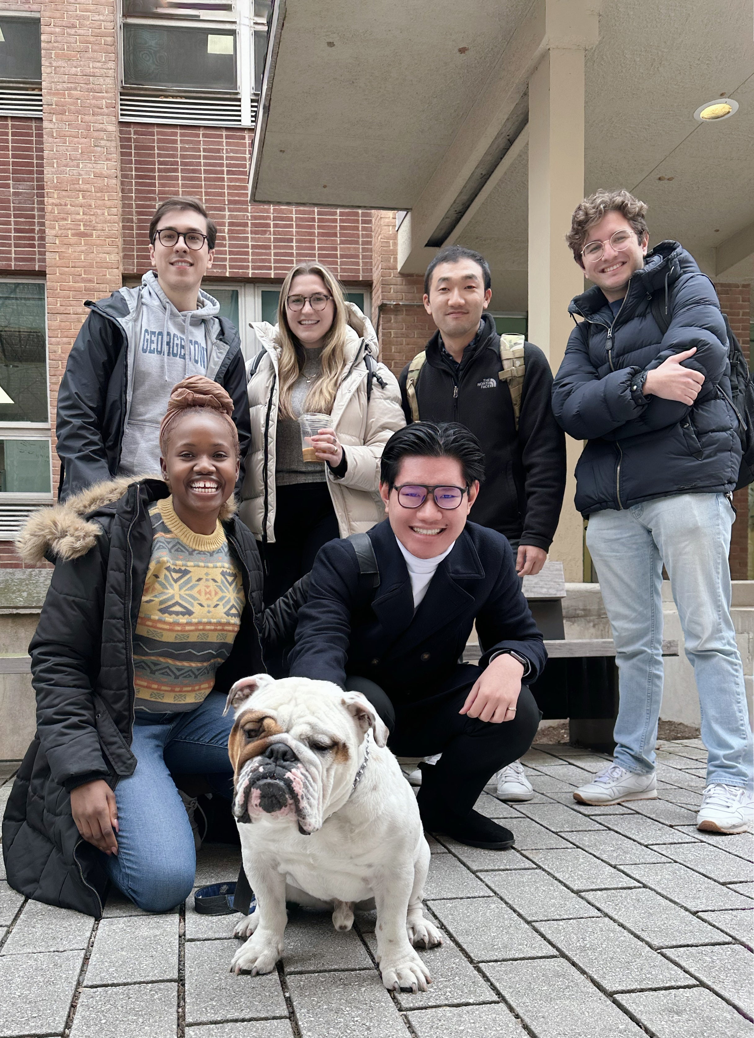 Nguyen and friends pose with Jack the Bulldog.