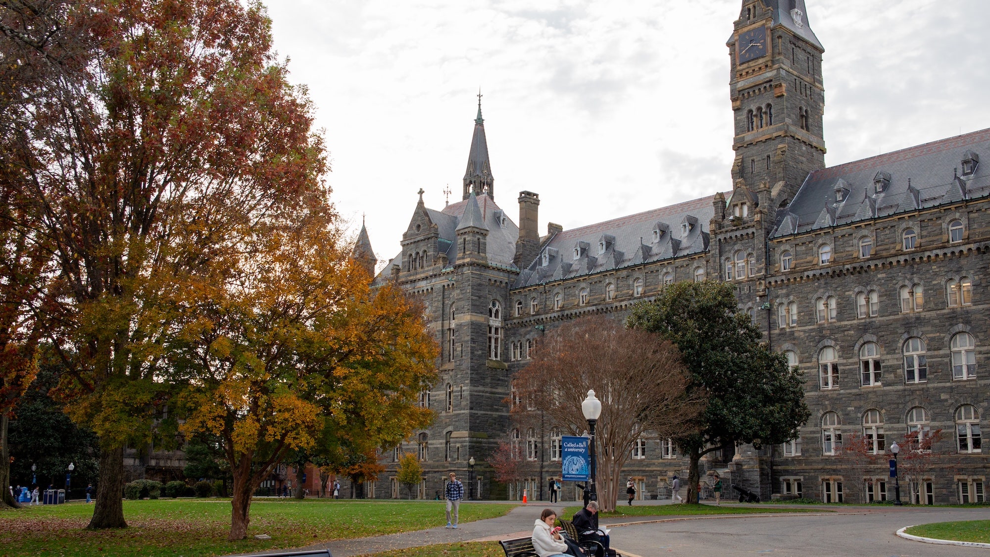 Trees with red and yellow leaves in front of Healy Hall on Georgetown University's campus during a fall day