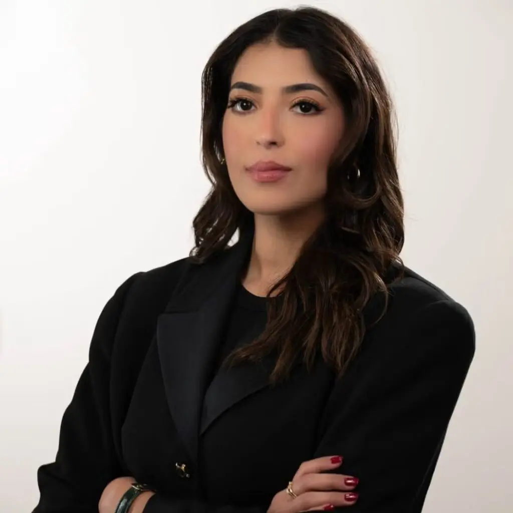 Hessa Alyahya wearing a black blazer and a black shirt.