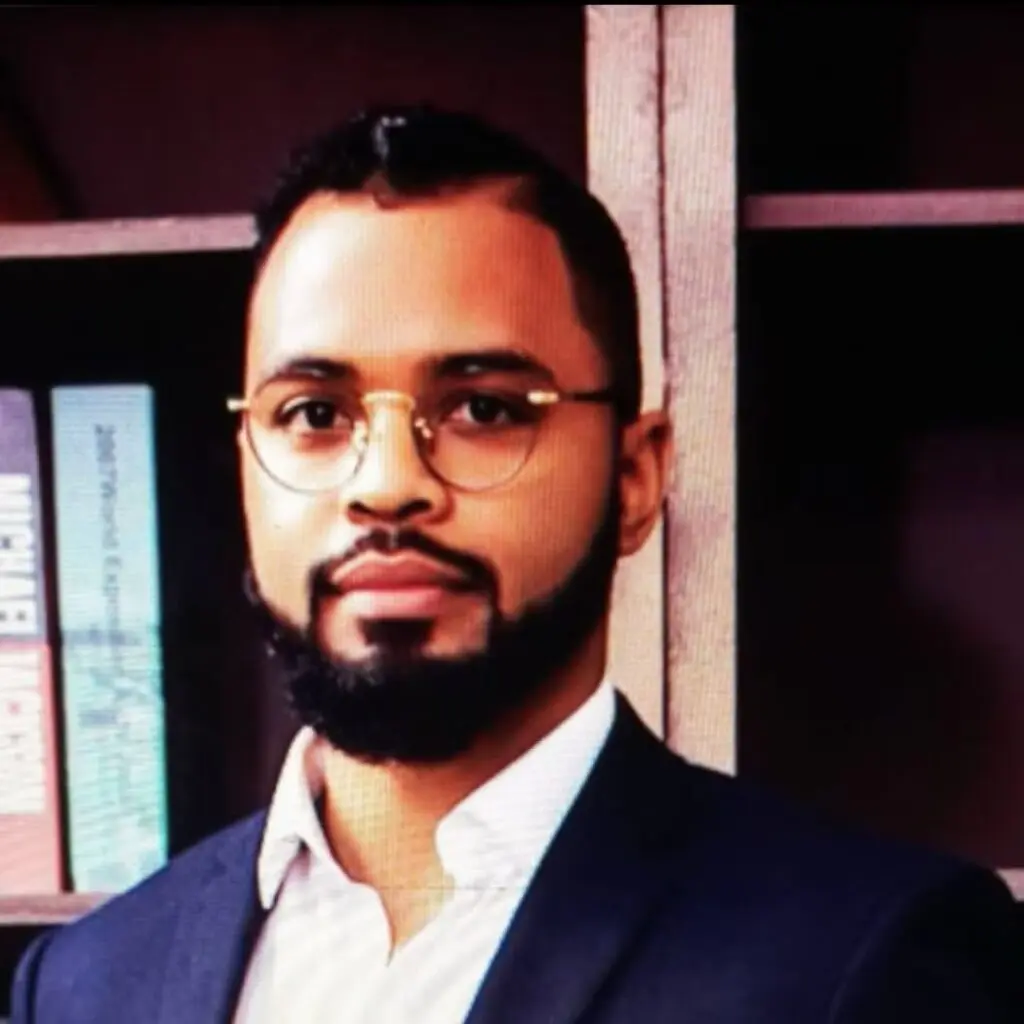Ibrahim N Daou wearing a blue blazer and a white button-down shirt with glasses.