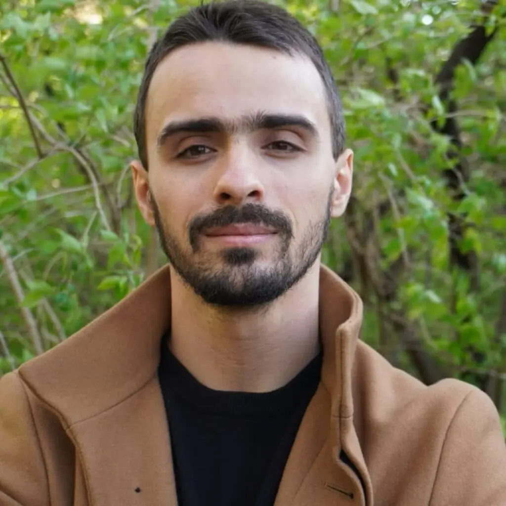 Jeremy Kundtz wearing a brown jacket and a black shirt.