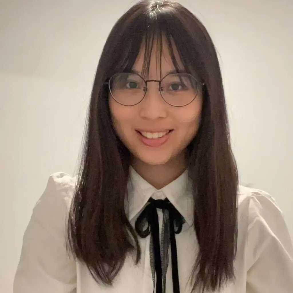Jessica Shiao wearing a white blouse with glasses.