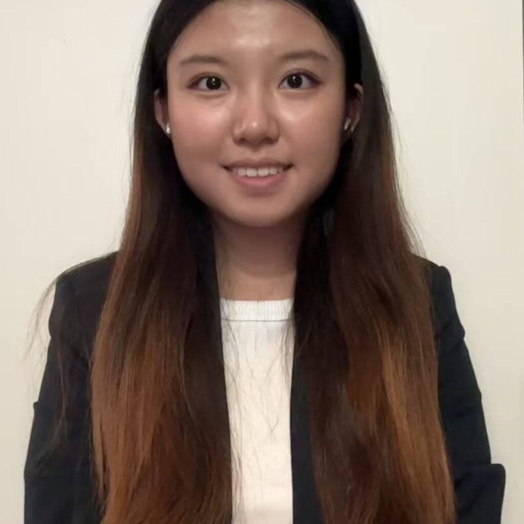 Jessie Hu wearing a white shirt and black blazer.