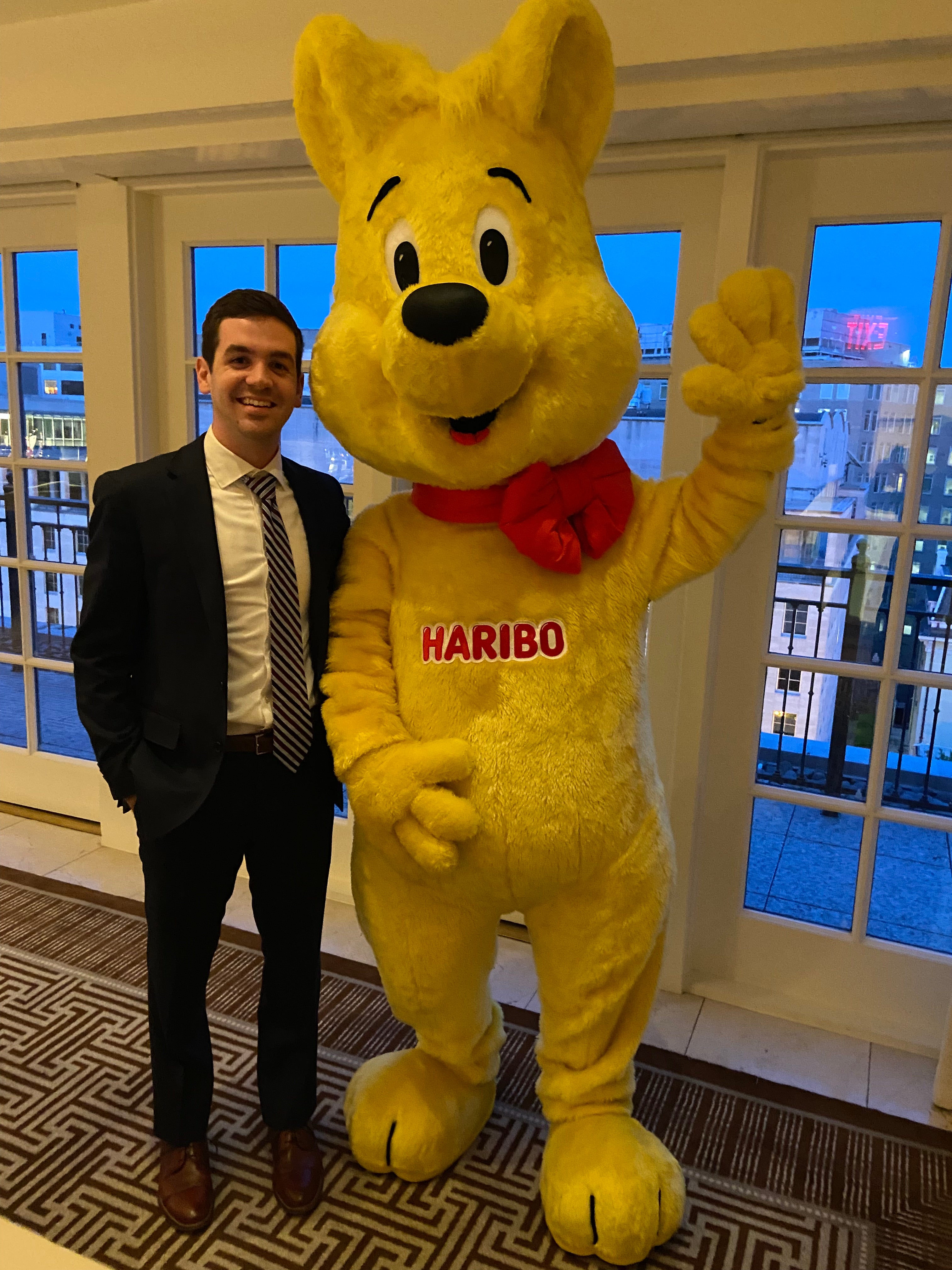 Joe Locher stands with the Haribo mascot.