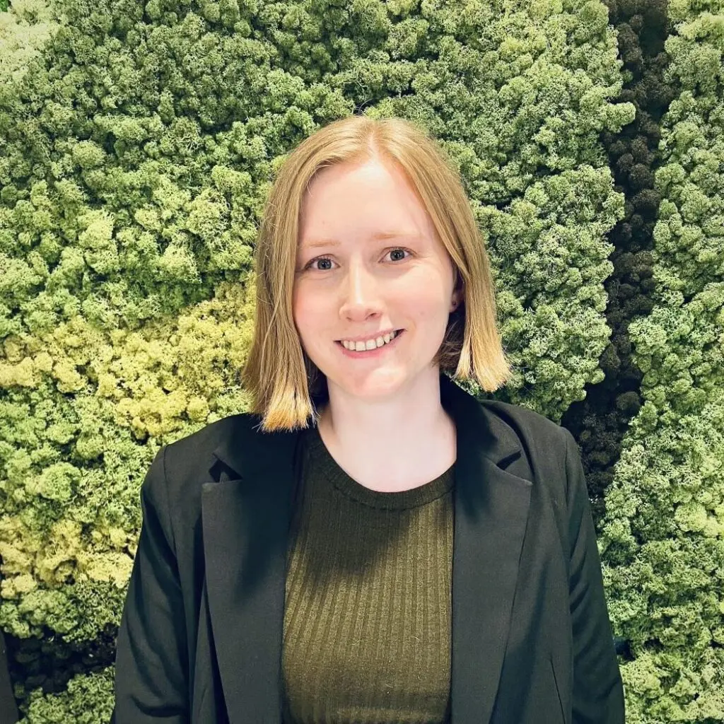 Kamilla Ruppman wearing a dark blazer and a hunter green sweater.