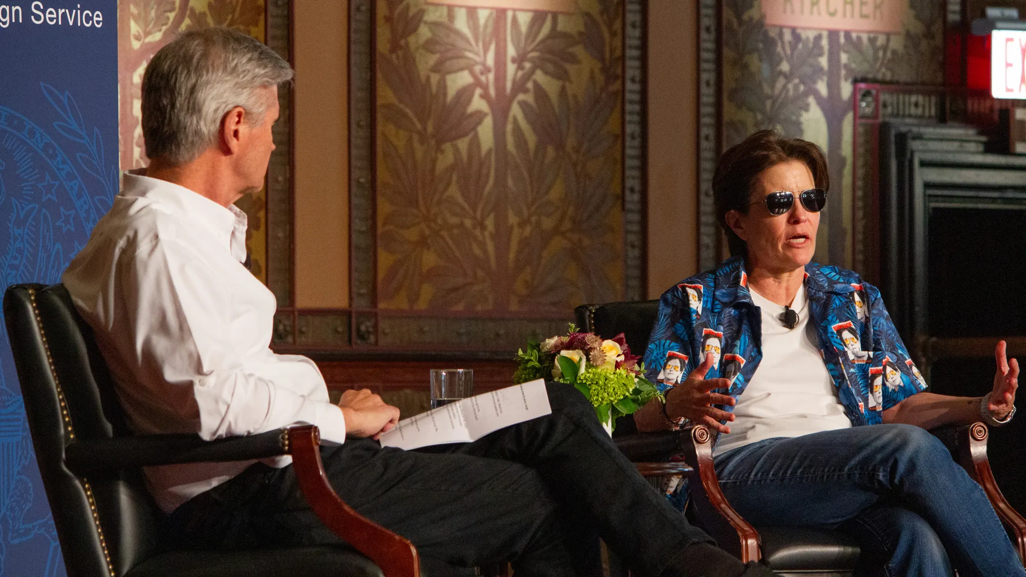 Kara Swisher being interviewed on stage, wearing sunglasses. She and the interviewer are sitting down, she is talking to the audience.