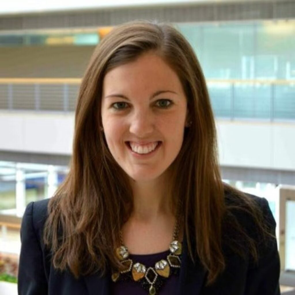 Kristen Robinson wearing a black blazer and statement necklace.