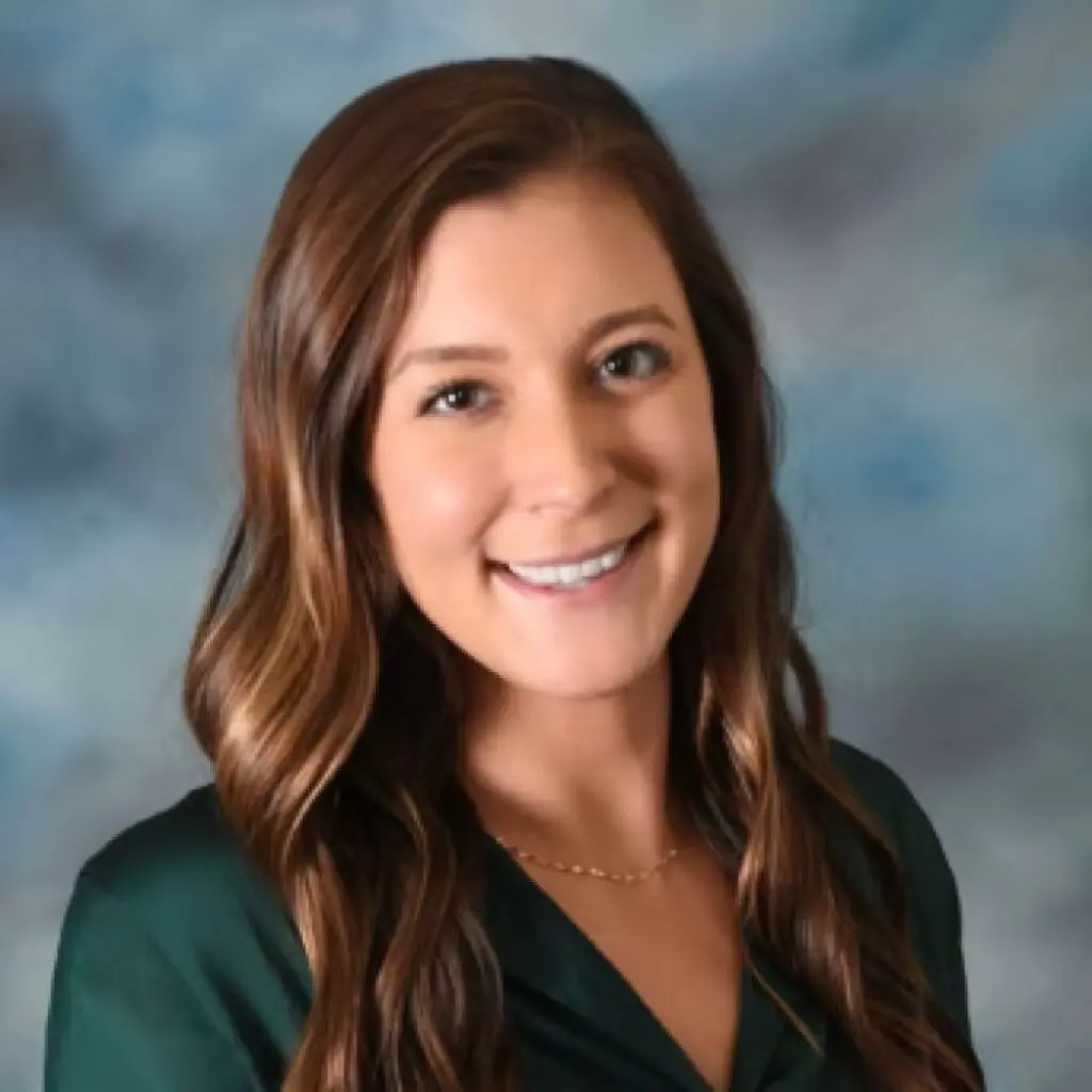 Kylee McVicker wearing a green blouse and a gold necklace.