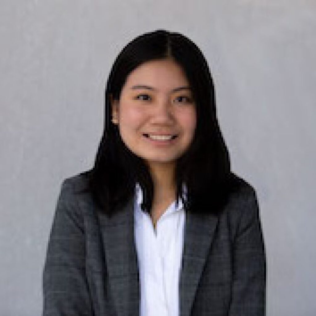 Lam Tran wearing a gray blazer and white shirt.