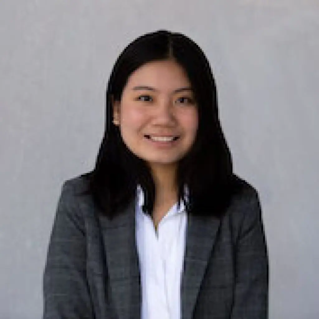 Lam Tran wearing a gray blazer and white shirt.