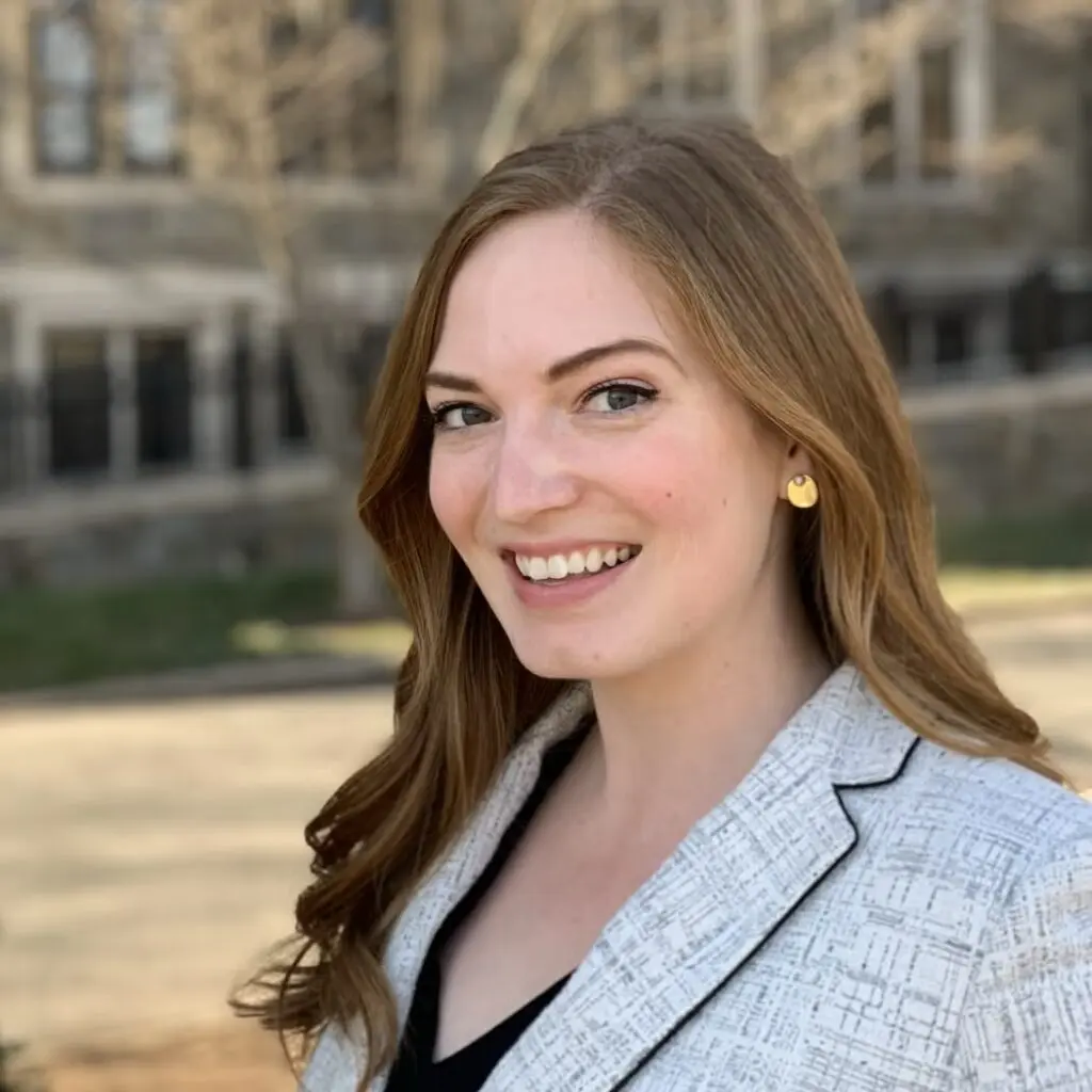 Laurie Batschi wearing a white plaid blazer and a black blouse.