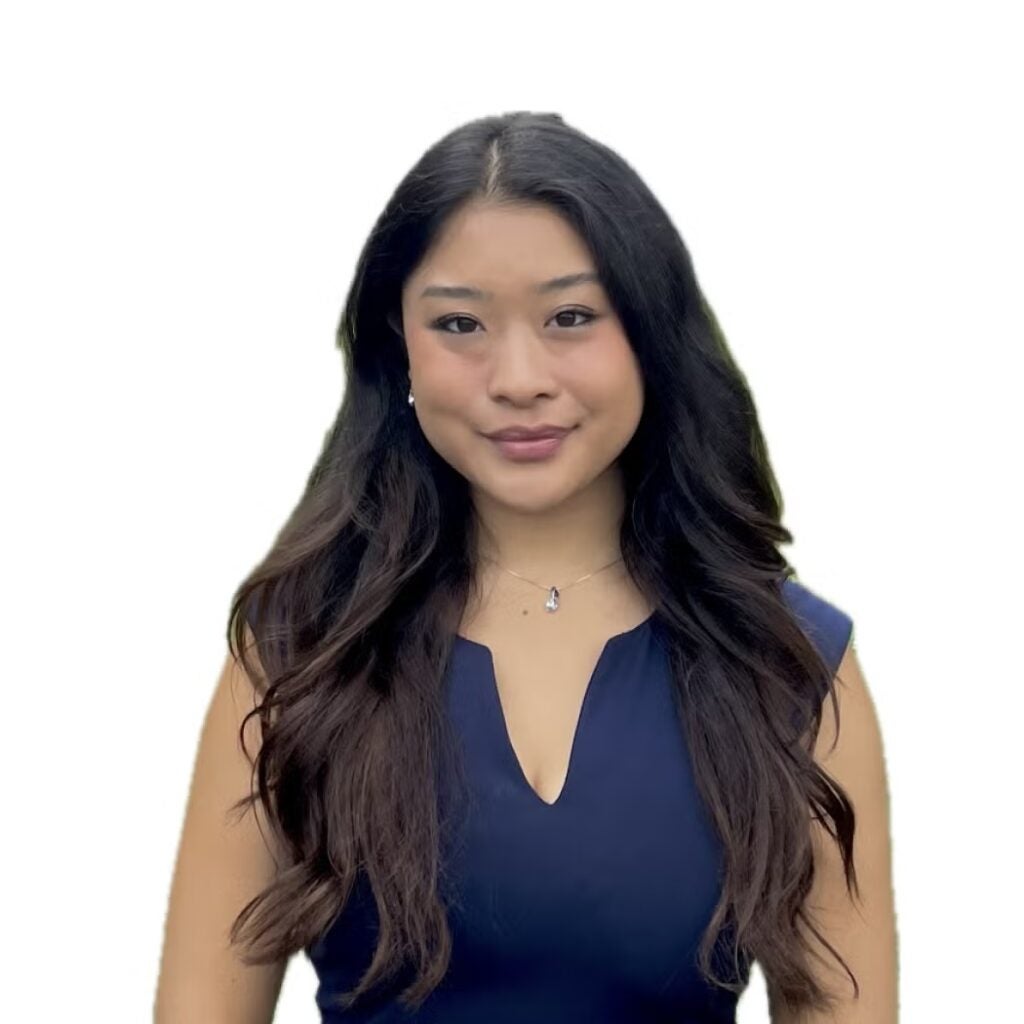 Lei Nishiuwatoko wearing a blue dress shirt.