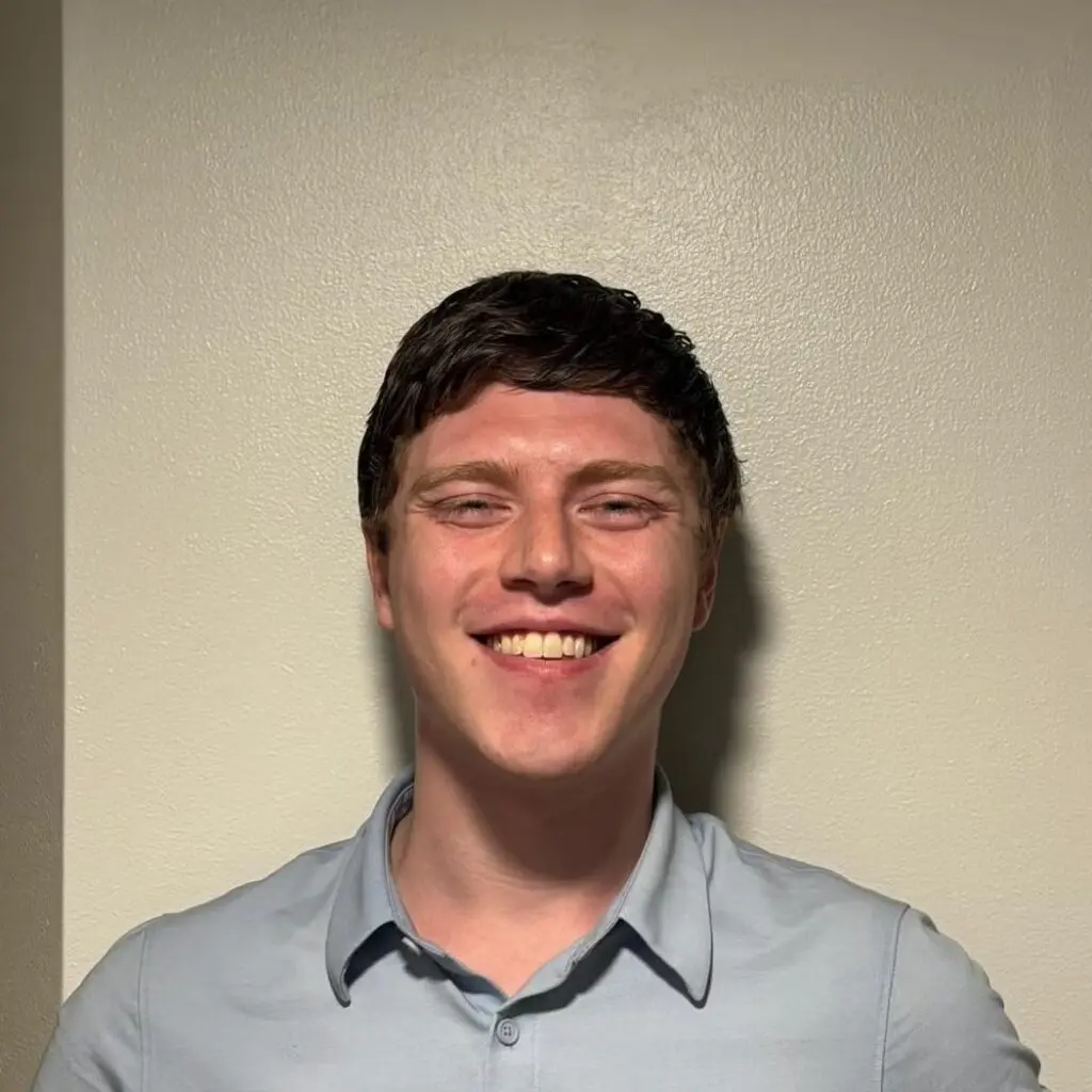Liam Paup wearing a gray button-down shirt.