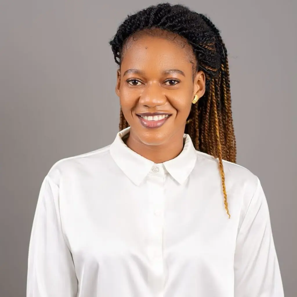 Linda Christopher wearing a white button-down shirt.
