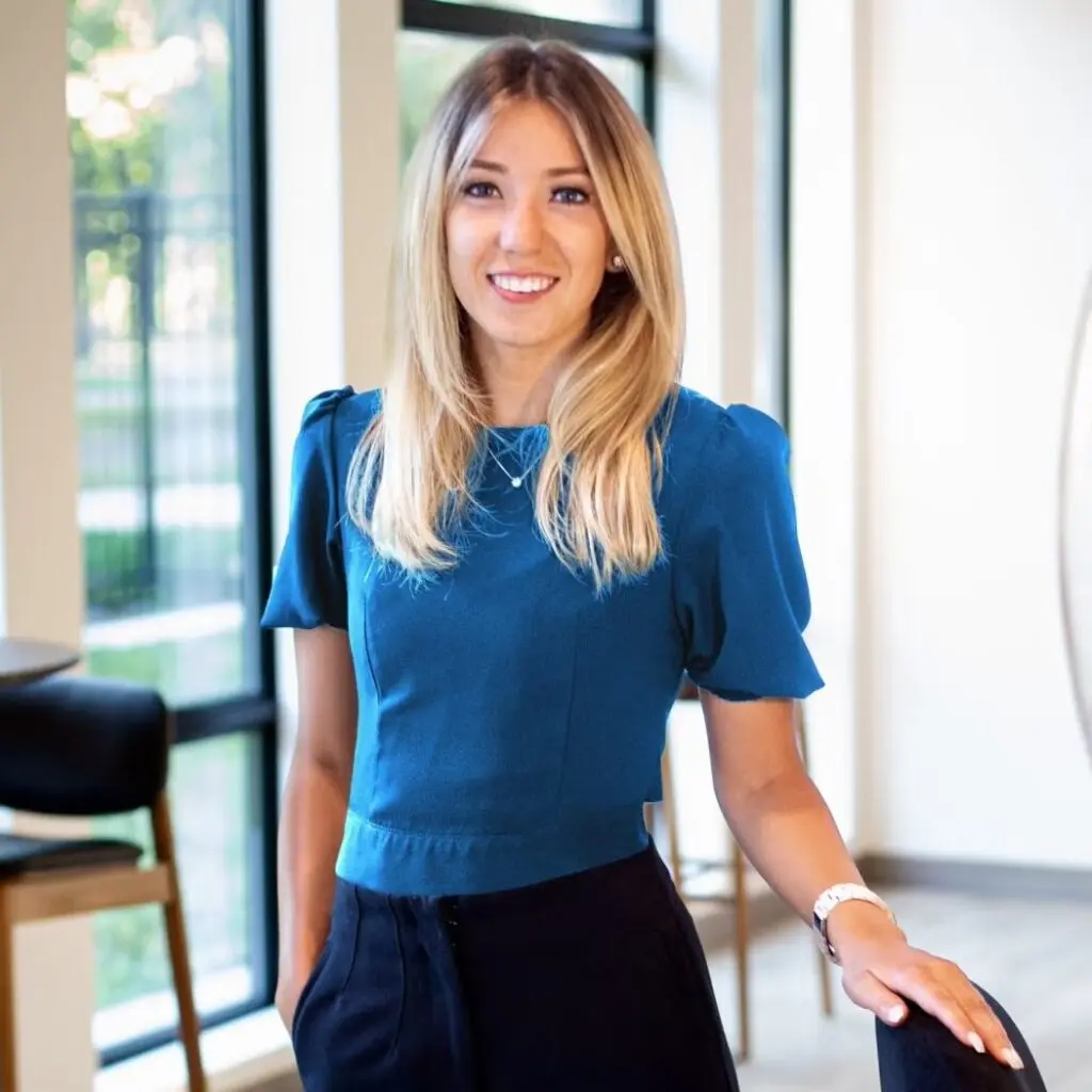 Madison Lommen wearing a blue blouse and navy blue pants.