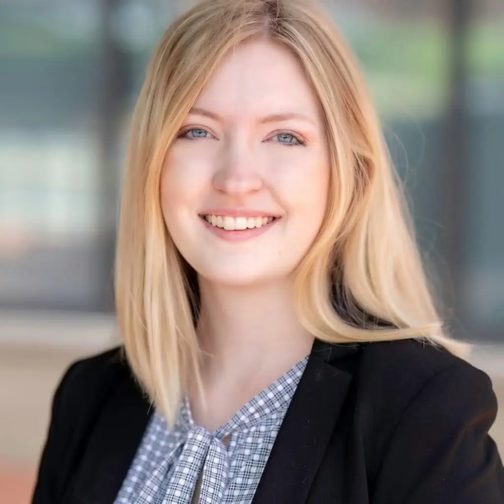 Maeve Knepper wearing a gray and white checkered shirt and a black blazer.