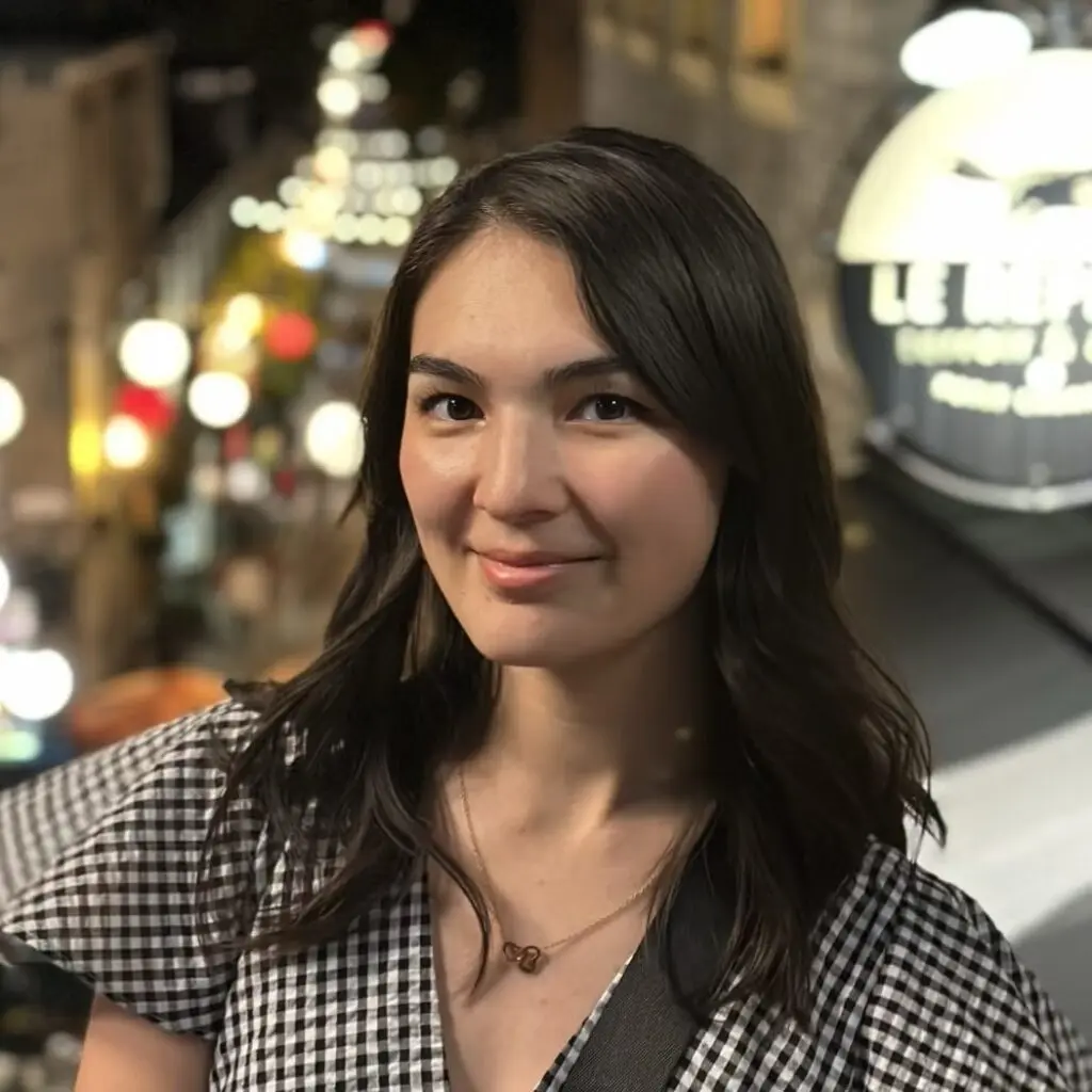 Malika Navruzova wearing a black-and-white checkered shirt.