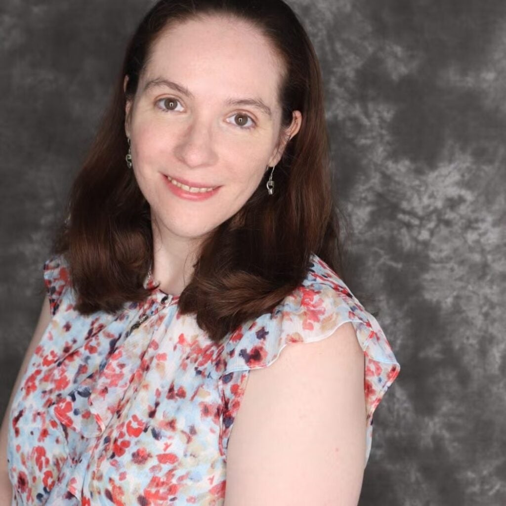 Meg Kline wearing a floral blouse.