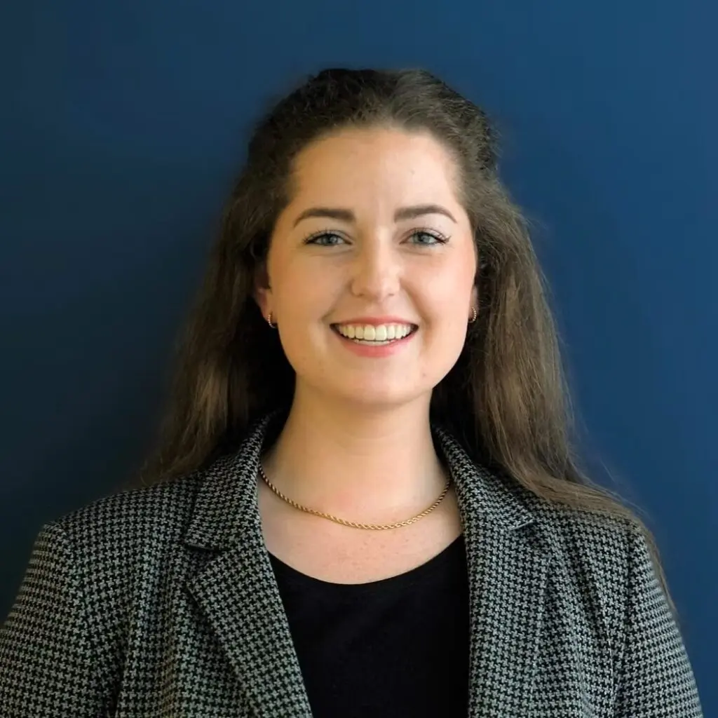 Molly Knapp wearing a houndstooth blazer and black shirt.