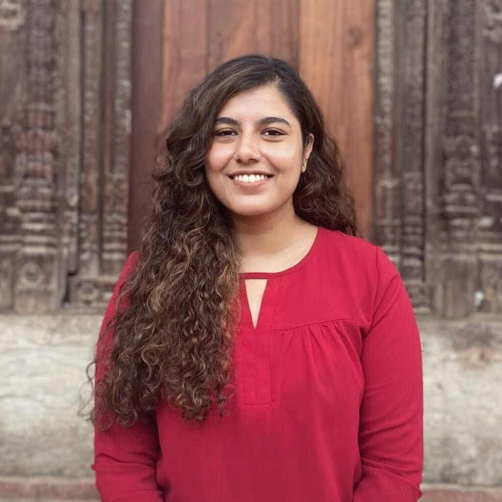 Monica Khanal wearing a red blouse.