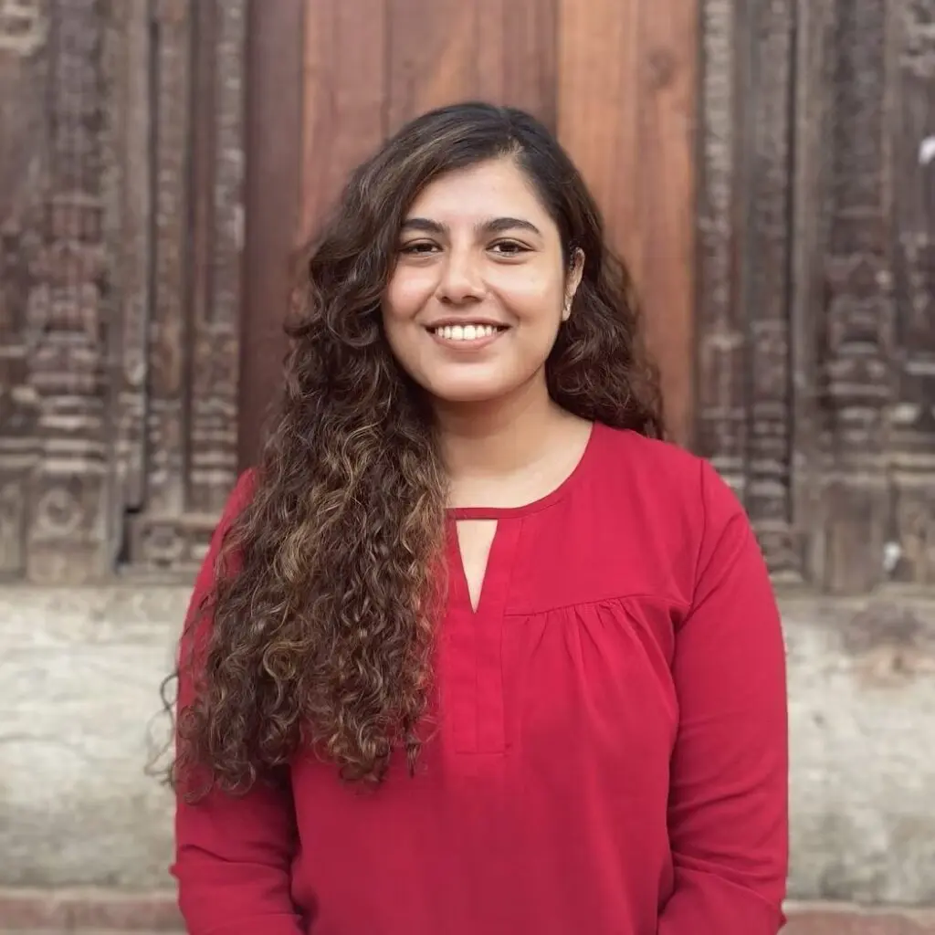 Monica Khanal wearing a red blouse.