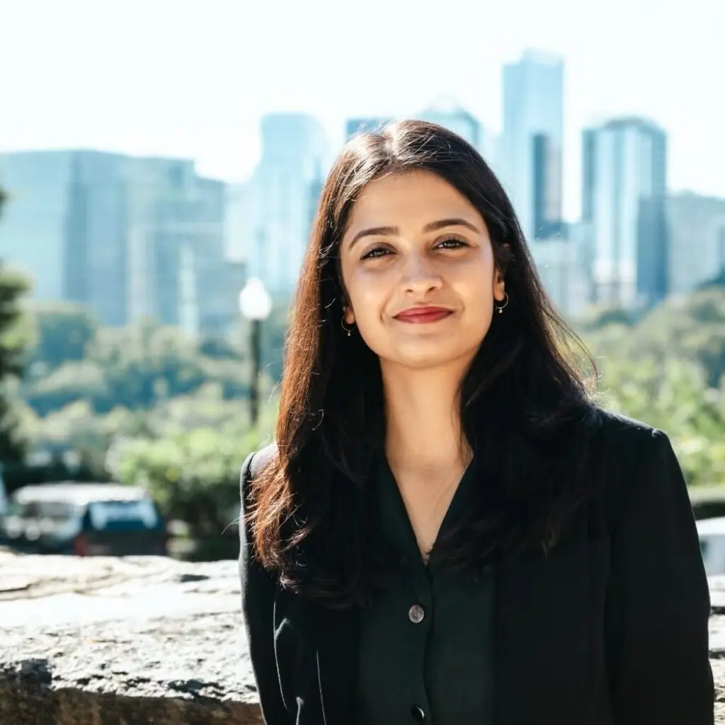Natasha Todi wearing a black blazer and a black shirt.