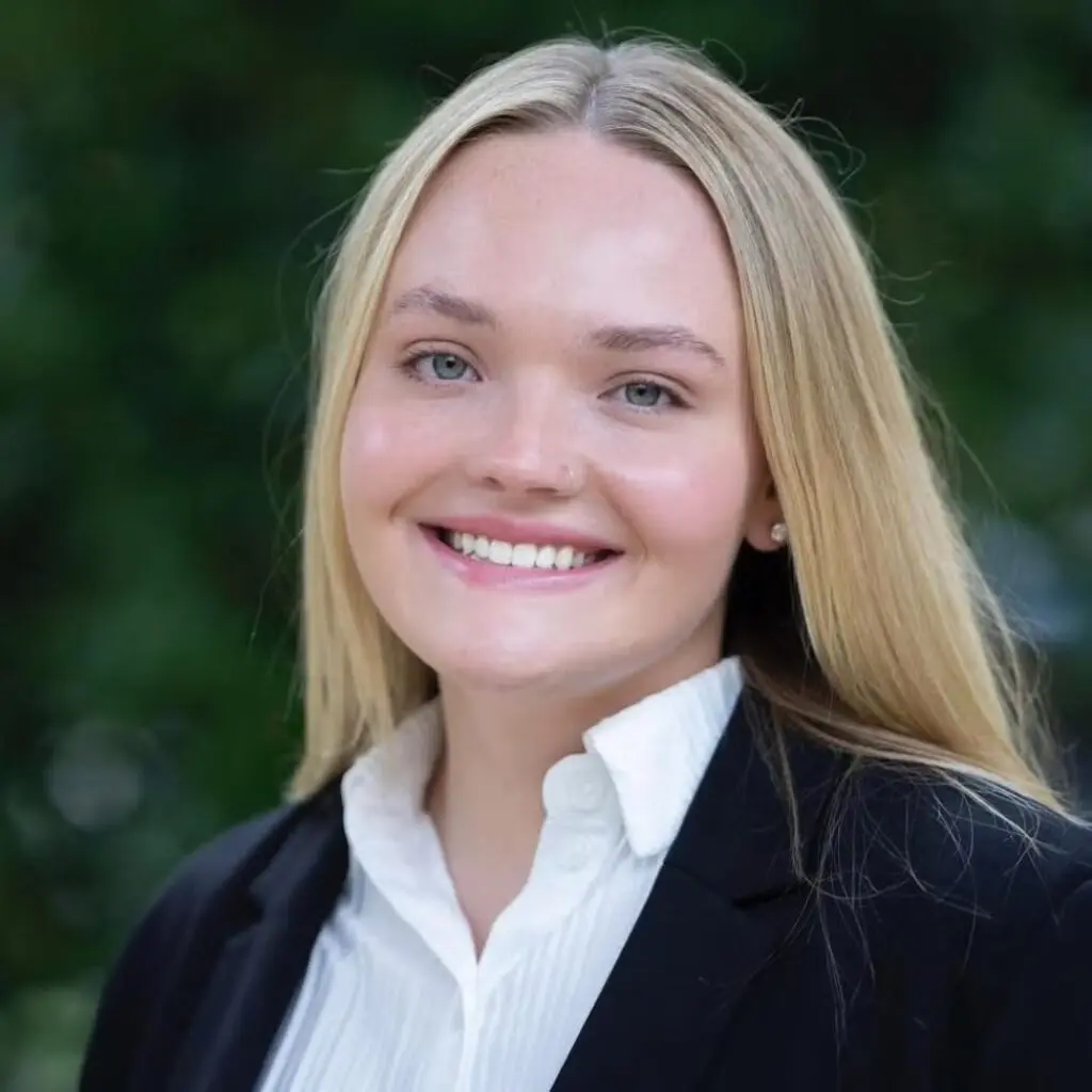 Payton Blaney wearing a black blazer and a white button-down shirt.