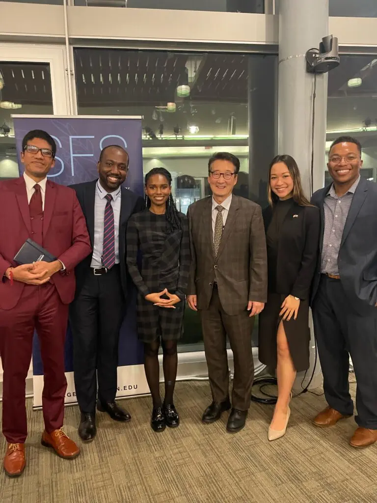 Salamata Bah and her friends pose with Professor Victor Cha at a holiday party.