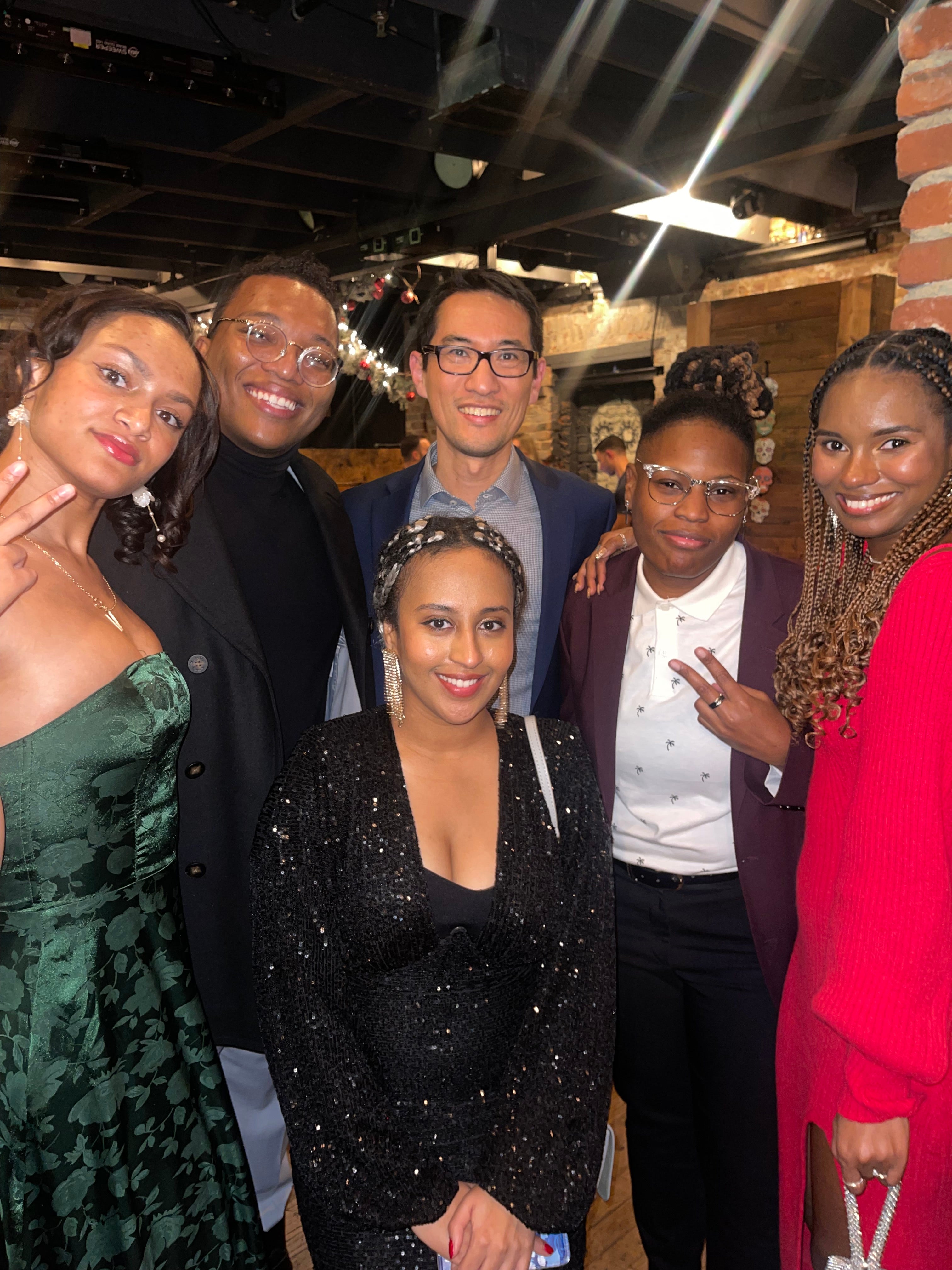 Salamata Bah and her friends pose with Professor Yuhki Tajima at the Asian Studies holiday party