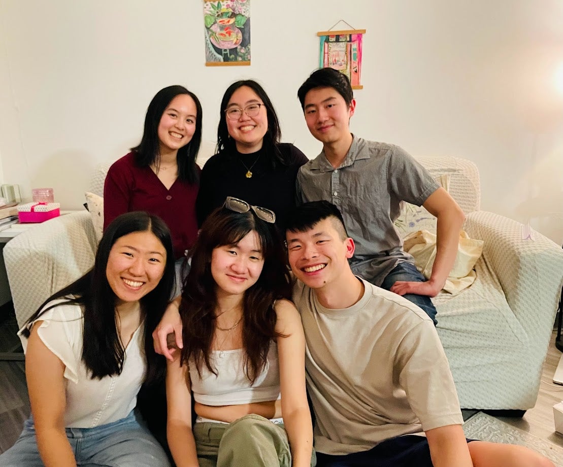 Sam Lie sits on the floor with five other Chinese students.