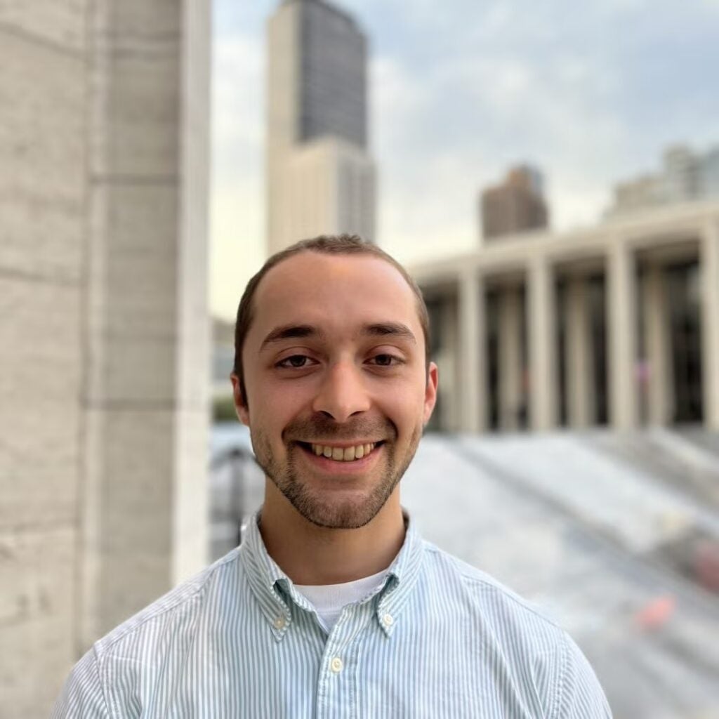 Theo Malhotra wearing a striped button-down shirt