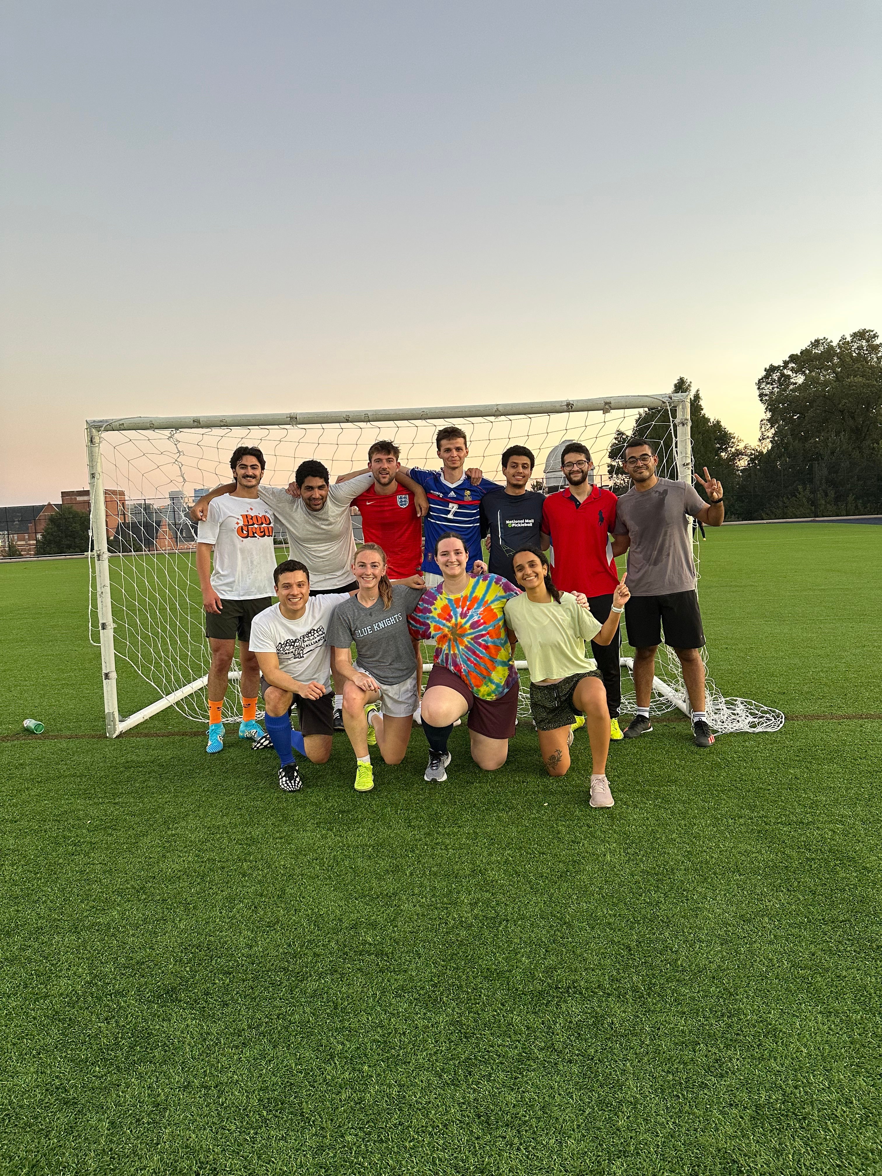 Angie Wright poses with 10 of teammates on her intramural soccer team in front of the soccer goal.