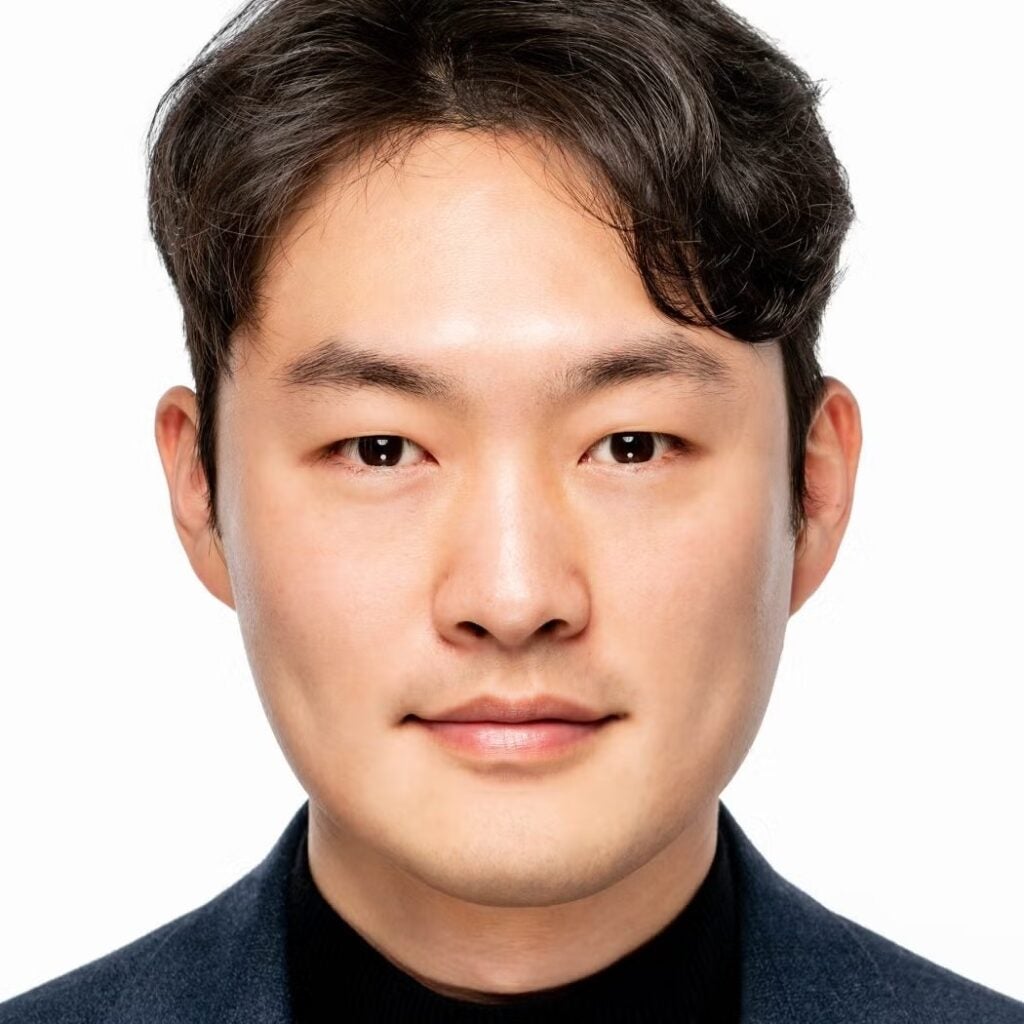 Yoon Kyum Kim wearing a dark shirt.