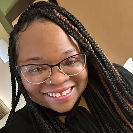 Headshot of Brittanie King, wearing glasses and smiling.