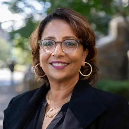 Headshot of Rahima Chaudhury smiling, wearing glasses.
