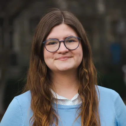 Headshot of Shelby Reese wearing a baby blue sweater.