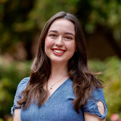 Headshot of Siobhan Cooney smiling, wearing a light blue blouse.