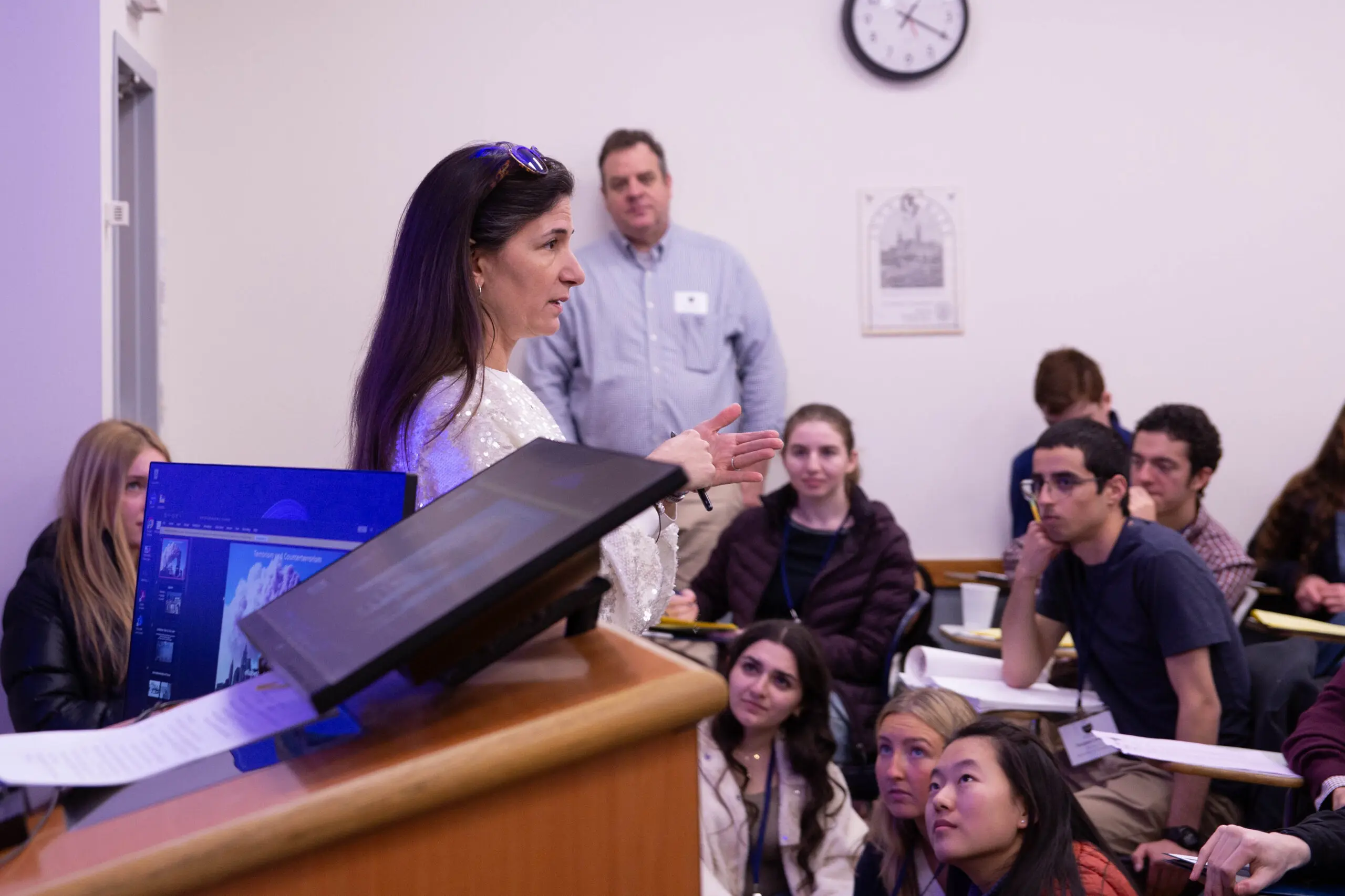 Professor Elizabeth Grimm teaching as students listen intently.
