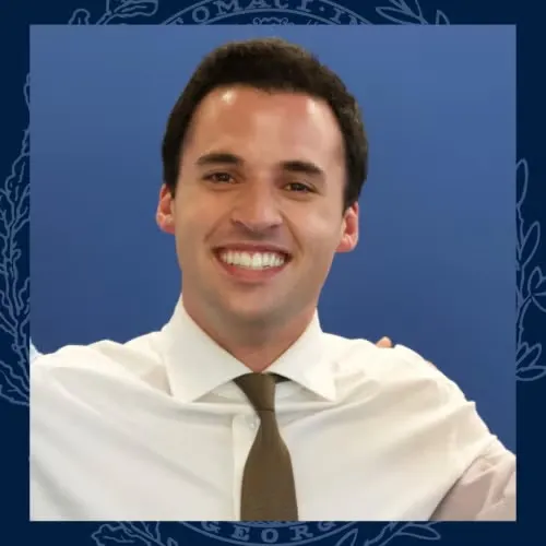 Headshot of Darren Hall in white shirt and brown tie.