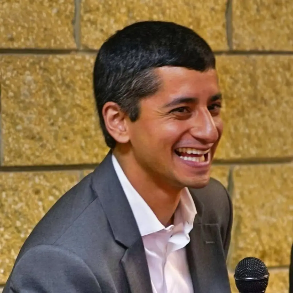 Rajan Marang wearing a gray blazer and white button-down shirt.