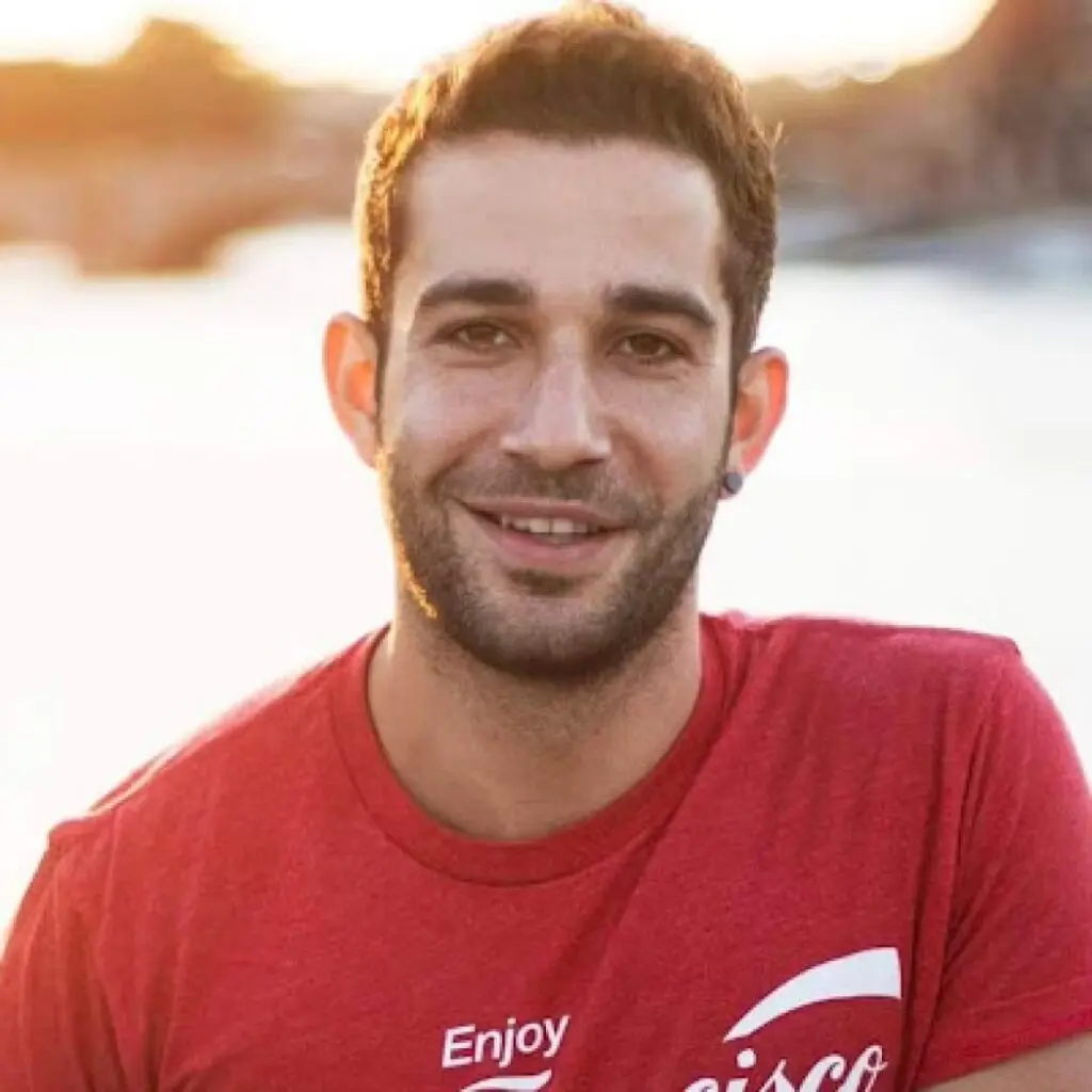 Ziad Reslan posing outdoors in a red t-shirt with white writing.