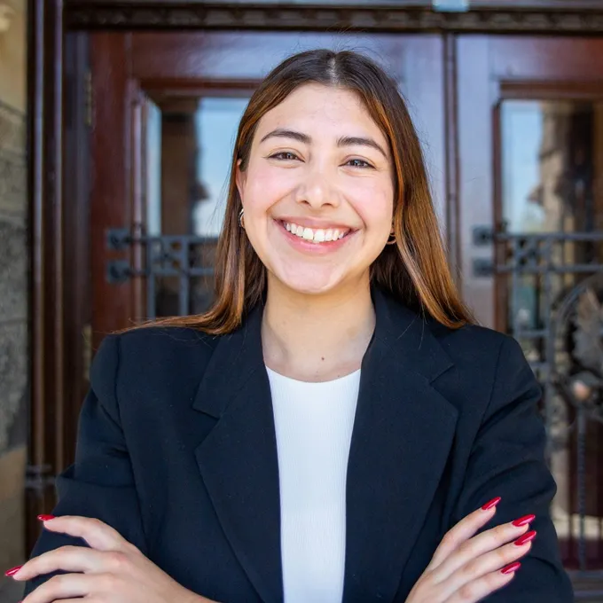 Headshot of Andrea Nucete Alvarado smiling. She is wearing ab blazer.