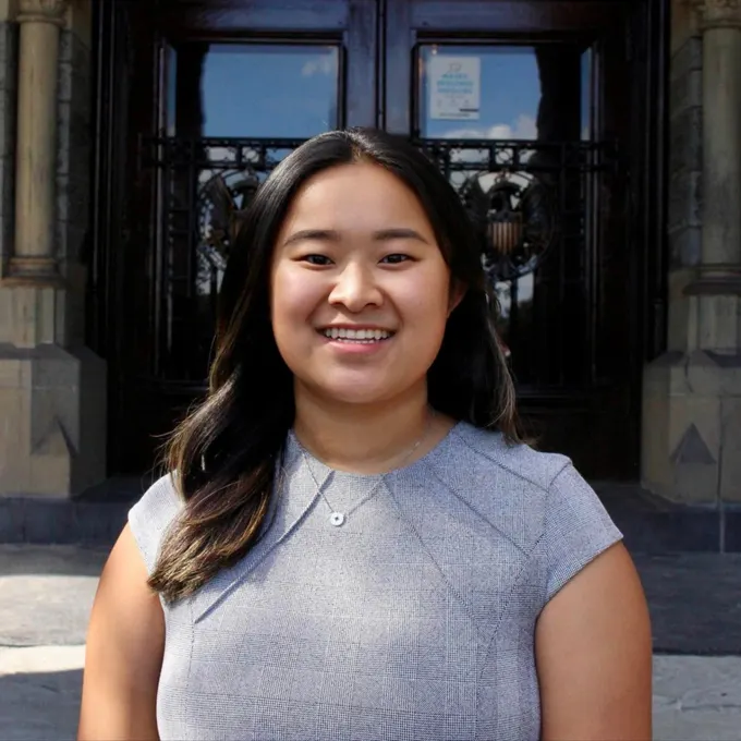 Headshot of Esther Li smiling, wearing a business dress