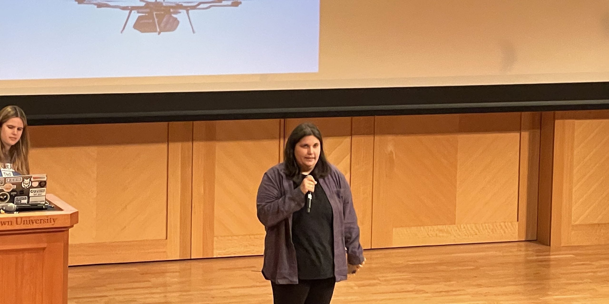 Photo of a student presenting on stage.