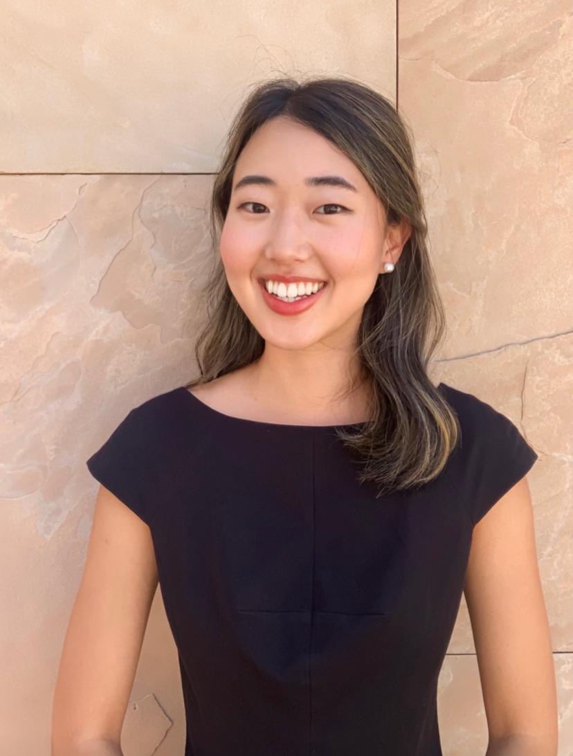 Headshot of Esther Jung smiling, wearing a black blouse.