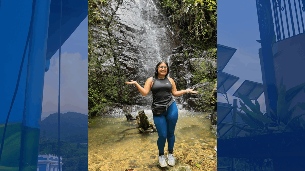 A picture of Priscila Putzulu standing by a waterfall on top of a background of solar panels.