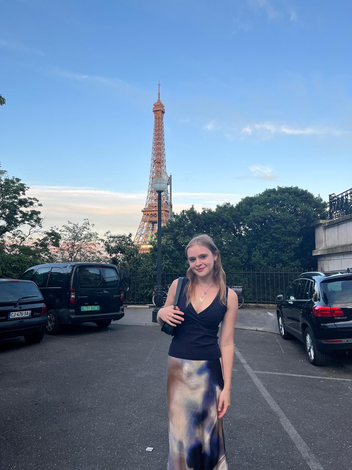 Talia Martin stands in front of the Eiffel Tower.